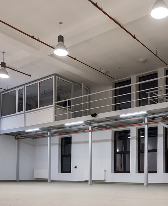 interior of modern open space featuring upper level with glass windows bright lighting and ample room for 4 activities