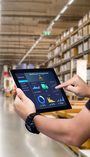 person using tablet for warehouse management displaying data and statistics with a modern inventory system and tracking tools in a large warehouse facility