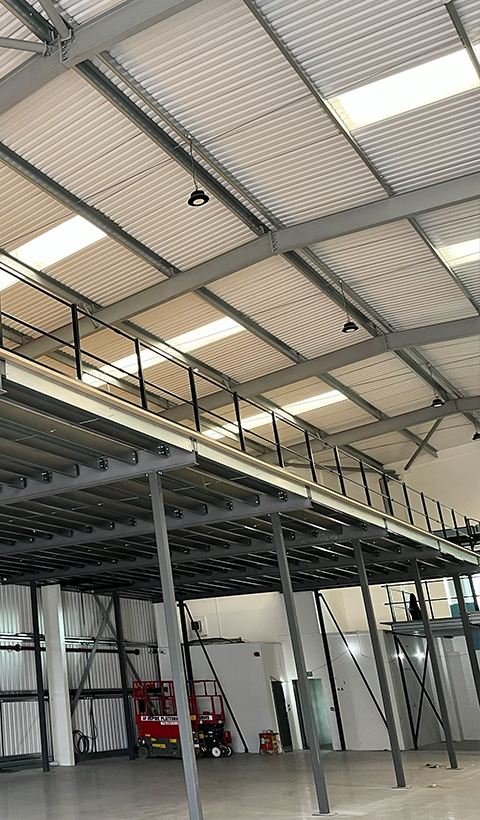 spacious industrial interior with high ceilings and a balcony area showcasing modern design features suitable for a 14 thousand square foot warehouse space