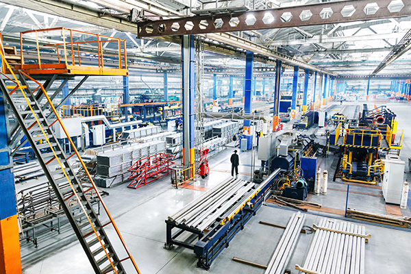 large industrial workspace with machinery and equipment for production six operational areas and metal materials arranged on the floor