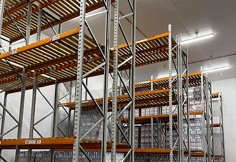 a well organized storage facility featuring multiple high metal racks with wooden slats holding various items showcasing efficiency in an 8 level shelving system