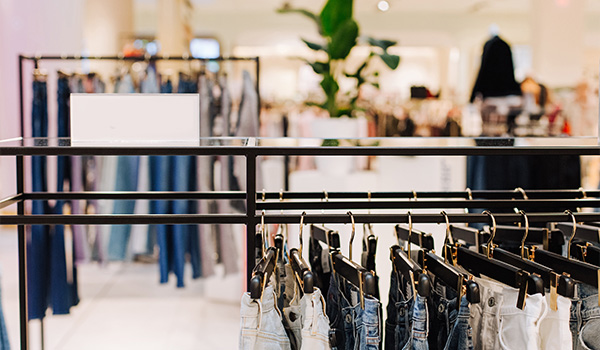 clothing rack displaying denim jeans in a stylish retail store featuring a variety of jeans for all sizes including 8 options