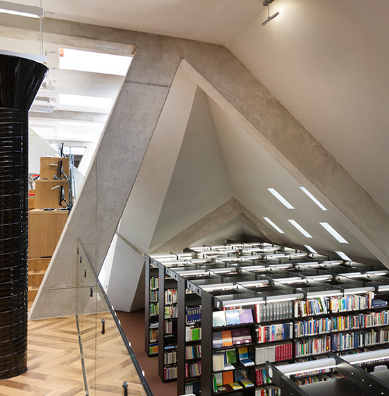 modern library interior with unique architectural angles featuring bookshelves and natural light design elements 4 books reading space
