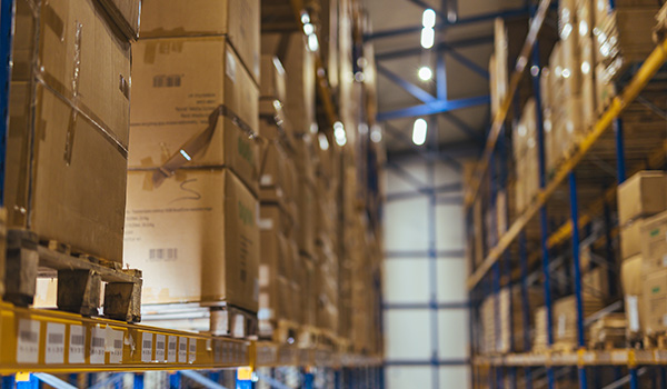 warehouse shelves filled with stacked cardboard boxes organized for efficient storage and shipping six key inventory items visible
