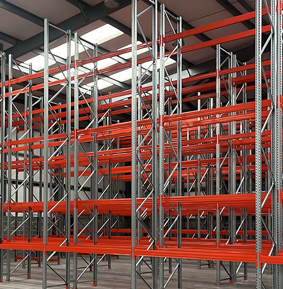 industrial shelving units with red beams in a spacious warehouse showcasing efficient storage solutions and organization 3 tier design