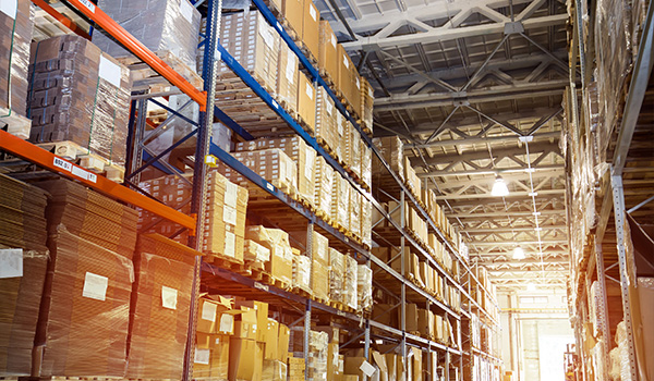aerial view of a warehouse interior showing tall shelves filled with boxes organized efficiently highlighting five key storage areas