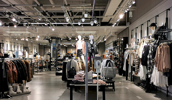 modern clothing store interior showcasing mannequins stylish apparel and fashion items seven outfits displayed prominently