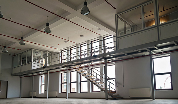 spacious modern interior featuring upper deck with stairs and large windows 8 workstations natural light