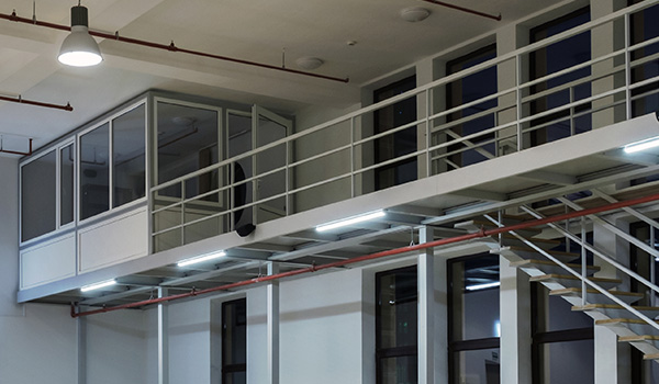 modern office interior with glass balcony and stairs featuring efficient lighting and open space design suitable for five people collaboration
